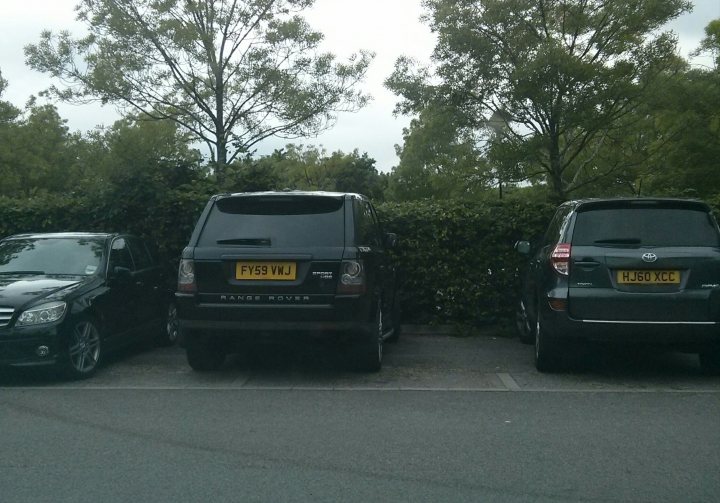 A truck parked in a parking lot next to a car - Pistonheads