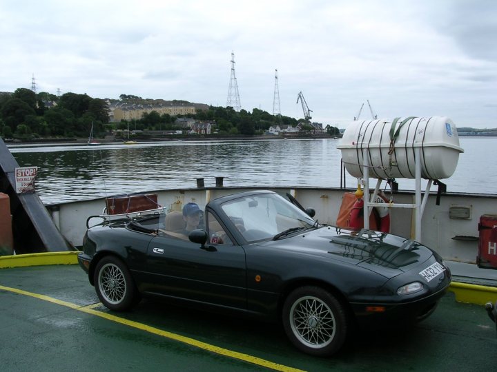 A boat with a dog sitting on top of it - Pistonheads