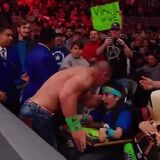 John Cena celebrating his victory with a fan ringside