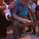 Man on crutches kneeling with peaceful protesters