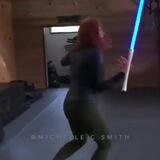 Women shows off her amazing skills with a lightsaber