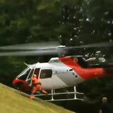 Pilot keeping helicopter level to horizon on a slope he cannot land on