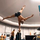 This acrobat has serious strength in his upper body to be able to do this.