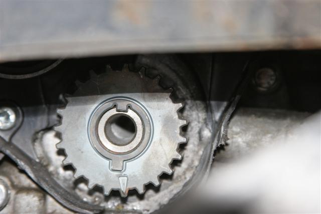 Timing Belt Pistonheads Mkg Astra - The image shows a close-up view of a mechanical part, featuring a metal gear with several teeth. The gear appears to be part of a larger machinery, given the presence of other metal parts and what seems to be a metallic frame or housing. There are visible bolts and rivets, suggesting that this is an assembly that needs to be secured. The image conveys a sense of industrial machinery and the inner workings of an engine or other mechanical system. The focus is on the texture and shape of the gears, emphasizing the mechanical precision and structure required in such components.