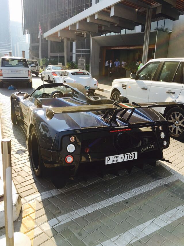 Middle East spotted thread - Page 99 - Middle East - PistonHeads - The image captures a scene on a street where a black sports car is the focal point. It's parked on the side of the road, and its sleek design contrasts with the surrounding environment. The car is adorned with a European registration plate and has various aerodynamic modifications on the back, suggesting it might be used on the race track.

In the background, a row of parked cars is visible, including another European car and a white SUV. These vehicles, along with the sports car, contribute to the busy city street atmosphere. The architecture of the buildings lining the street and the presence of pedestrians further emphasize that this is a bustling urban area.