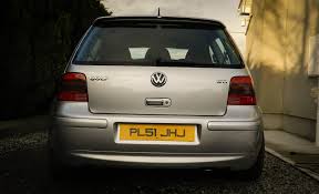 Licence plates in Northern Ireland odd font? - Page 1 - General Gassing - PistonHeads - The image depicts the back of a silver-colored Volkswagen. The VW logo is prominently displayed on the trunk. The license plate reads "PL5JHU". The vehicle appears to be parked in a driveway with a white wall visible in the background. There are trees with green foliage behind the car.