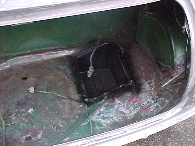 Purchase Pistonheads Advice - The image shows the interior of a car's door mechanism that appears to be malfunctioning or in need of repair. The wiring is exposed both in the area of the latch as well as around the frame of the car door. The condition of the wiring might indicate a broken or ineffective locking mechanism. The image captures the complexity of car door mechanisms, presenting a view into the inner workings of what is often taken for granted. The color palette is dominated by the metallic hue of the car interior, with hints of green and pink that could indicate wiring colors or the overall aesthetic of the car's interior.