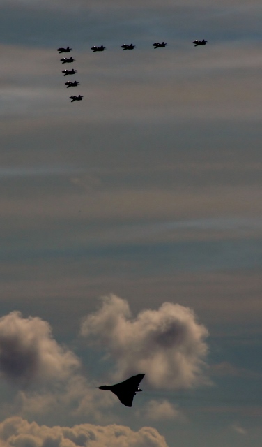 XH558.......... - Page 276 - Boats, Planes & Trains - PistonHeads - The image captures a breathtaking scene of nine fighter jets flying in unison against the backdrop of a cloudy sky. Each jet has left behind a graph topped path, creating an intricate pattern in the heavens. They are scattered across the sky, suggesting a training exercise or display. The striking contrast between the dark silhouette of the jets and the light grey sky adds a dynamic element to the scene.