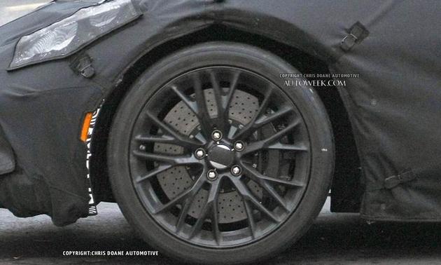 C7 Z0? Mule - Page 1 - Corvettes - PistonHeads - The image shows a close-up view of the front wheel and fender of a car. The car appears to be black or dark in color. The wheel is characterized by a starburst or five-point design at its center. On the fender, there is a watermark with copyright information.