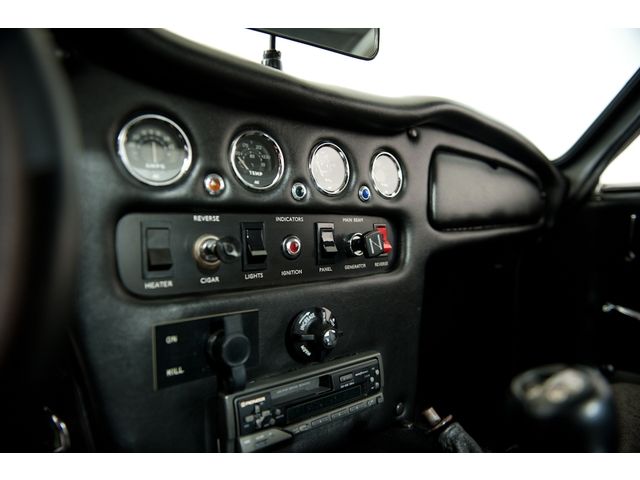 Early TVR Pictures - Page 65 - Classics - PistonHeads - This is a photograph taken from the perspective of someone near the dashboard inside a vehicle. The dashboard features a digital display with various buttons, gauges, and controls. The dashboard design has a modern and sleek appearance. It includes labeled functions like 'HEATER', 'AIR', 'MODULE', 'INDICTORS', 'CRAFT', and 'TOSS', suggesting the vehicle is a convertible or has customizable features. The focus is on the center console controls and the steering wheel, which is partially visible, indicating the vehicle's interior is being presented.