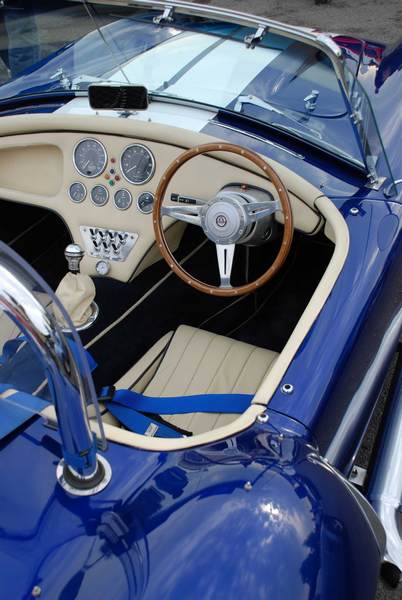 Pistonheads Supercar Sunday - The image shows the interior of a classic sports car, viewed from the top seat. The cockpit is well-equipped, displaying odometers and gauges on the dashboard. Visible are multiple dials and indicators on the instrument panel. The steering wheel is in the foreground, centered in the frame. The car's overall color scheme is blue and cream, with visible detailing and chrome accents.