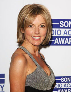 Vintage Totty Pistonheads - The image is a portrait-style photograph featuring a woman posing on a red carpet. She has short, light-colored hair styled cascading over one shoulder. The woman is smiling and looking directly at the camera, giving off a relaxed and approachable demeanor. She is wearing a sleeveless top that has a scoop neck and is textured, suggesting a casual yet stylish outfit for the event she is attending. The background of the image includes logos and text that indicate the event is an awards presentation for Sony, possibly the Academy Awards given the context and the text "SONY Academy Awards" being visible.