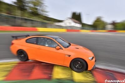 991 GT3 Prices  - 50 cars available! - Page 62 - 911/Carrera GT - PistonHeads - The image captures an exhilarating moment on a race track. A small, orange sports car is in motion, its body tilted as it rounds a curve. The car's position suggests it's on a speedway or race track with a playground of curves and straightaways. The curvature of the picture indicates it was taken from a moving car, adding a sense of speed to the scene.