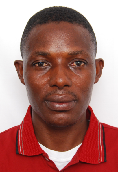 A man wearing a tie and a hat - The image is a close-up portrait of a male individual with a short, black hairstyle. He has a fair complexion and is wearing a red and white collared shirt with buttoned up to a buttonhole. The background is plain and white, which contrasts with his attire and accentuates his facial features. The expression on the person's face is neutral, and his head is slightly tilted to the left, giving a sense of a formal or professional photograph.