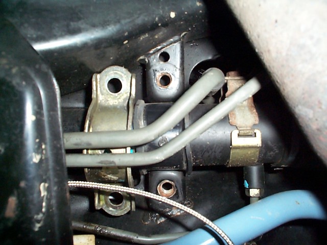 An old fashioned stove with a metal handle - Pistonheads - The image shows a close-up view of the engine bay of a black vehicle. At the center of the image, a metallic tube with a flange is prominently featured. Two bolts with washers attach the tube to a circular fabrication. Adjacent to the metallic tube is a blue hose, adding a pop of color to the otherwise monochrome palette of the image. Overall, the image provides a detailed glimpse into the intricate workings of an automotive engine.