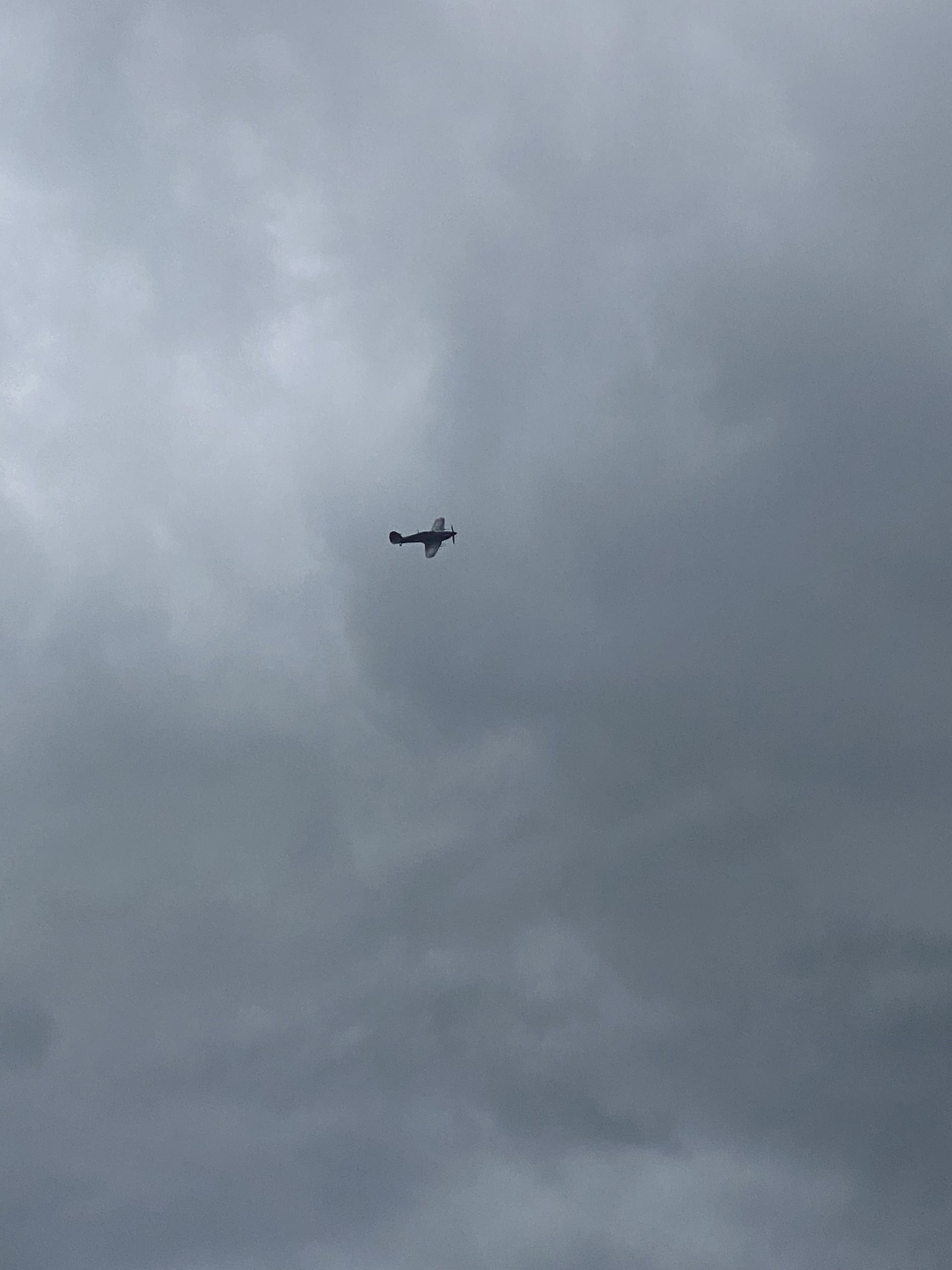 Cool things seen on FlightRadar - Page 437 - Boats, Planes & Trains - PistonHeads UK - The image shows a cloudy sky with a small airplane flying high. The plane is single-engine and appears to be in motion, leaving behind a trail that suggests it's moving through the air. The clouds are gray and heavy, indicating possibly poor weather conditions. The overall impression of the image is one of solitude or travel, with the lone aircraft soaring above the cloudy sky.