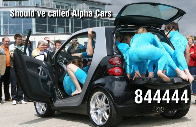 Pistonheads - The image portrays a humorous scene where a group of people, dressed in light blue covers, are pressed into the back of a black car. They are positioned in such a way that they seem to be squished together to fit in the vehicle. The car is surrounded by an audience, including people in the foreground who appear to be watching the spectacle. The scene has the words "Should've called Alpha Car" overlaid on it. The colors of the image are quite striking, with the black car and the bright blue covers standing out against the gray background. The setting appears to be an outdoor area, possibly a parking lot, based on the presence of a building in the background.