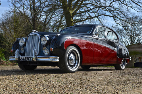 Lovely Cars: Interesting, Classic, Retro, Barge 5-10k - Page 60 - General Gassing - PistonHeads - The image showcases a classic car parked on a gravel driveway. The car is a vintage model, painted in a two-tone color scheme with the upper part in white and the lower part in red, creating an eye-catching contrast. The vehicle is positioned facing the camera, with its glossy finish reflecting the sunlight. The gravel surface on which the car is parked has tracks leading up to it, hinting at the car's past journeys. The car's unique design and the serene setting create a sense of nostalgia and luxury.