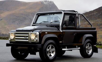 A truck that is parked in the grass - Pistonheads - The image showcases a rugged black Land Rover, parked on a road leading up a mountainside. The vehicle is captured in a 3/4 front view, with its robust leather interior visible. The grand landscape in the background features dramatic hills and adds a sense of adventure to the scene. This image encapsulates the vehicle's distinctive outdoor appeal, suggesting it's ready for any terrain.