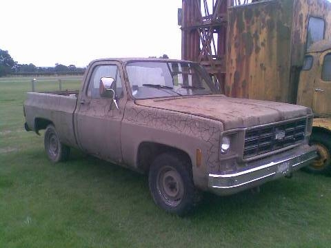 Trucks Chevy Pistonheads - In the image, an old, rusted truck is parked on a grassy area adjacent to another similar vehicle. The truck in the foreground has visible damage in its faded beige paint, with the rusted hood and cab suggesting a long history. The truck in the background appears less worn, with its faded yellow color and a missing door. There are no discernable texts or distinctive markings on either vehicle, indicating a lack of uniqueness that might have suggested ownership or agency connection. The open space and fading paint paint a picture of neglect and a bygone era.