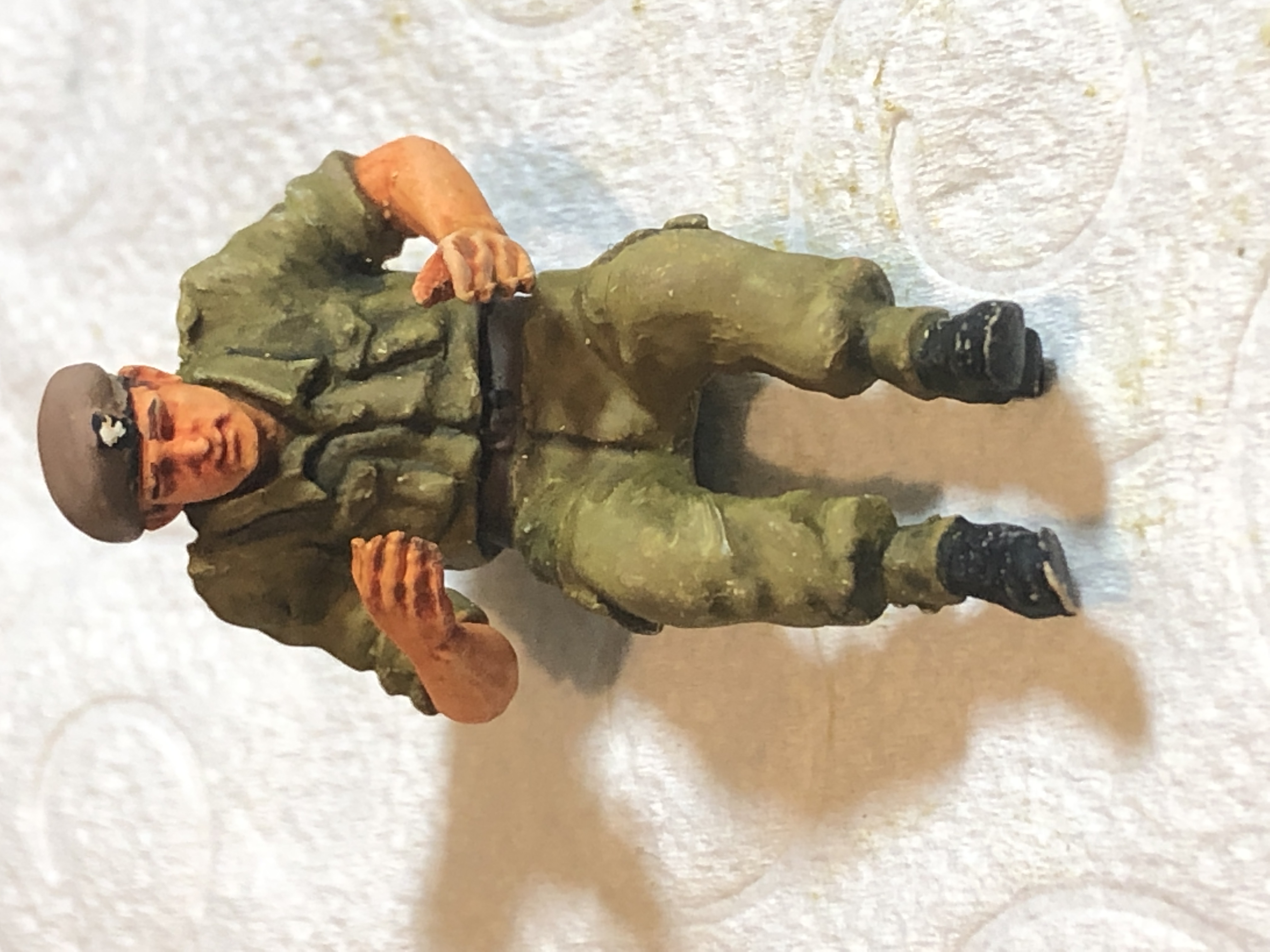 The thread where we can talk about painting figures. - Page 1 - Scale Models - PistonHeads - The image displays a small, green toy soldier. This figure is dressed in military attire, complete with a helmet and carrying what appears to be a rifle. The soldier is kneeling down on one knee, suggesting a pose of readiness or vigilance. Behind the toy, there's a contrasting background that consists of a plain white surface, which helps to highlight the vibrant green color of the soldier.