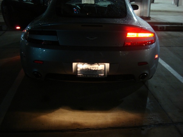 Pistonheads - The image captures a nighttime scene with a car parked in a parking lot. The car is on the right side of the frame, occupying most of the space with its rear facing the camera. The photo features a low angle, emphasizing the car's tail lights and license plate. The backdrop of the scene reveals a dimly lit environment, possibly indicating a dark parking lot at night. The photo's focus is on the car, creating a sense of solitude and quietness in the otherwise empty parking lot.