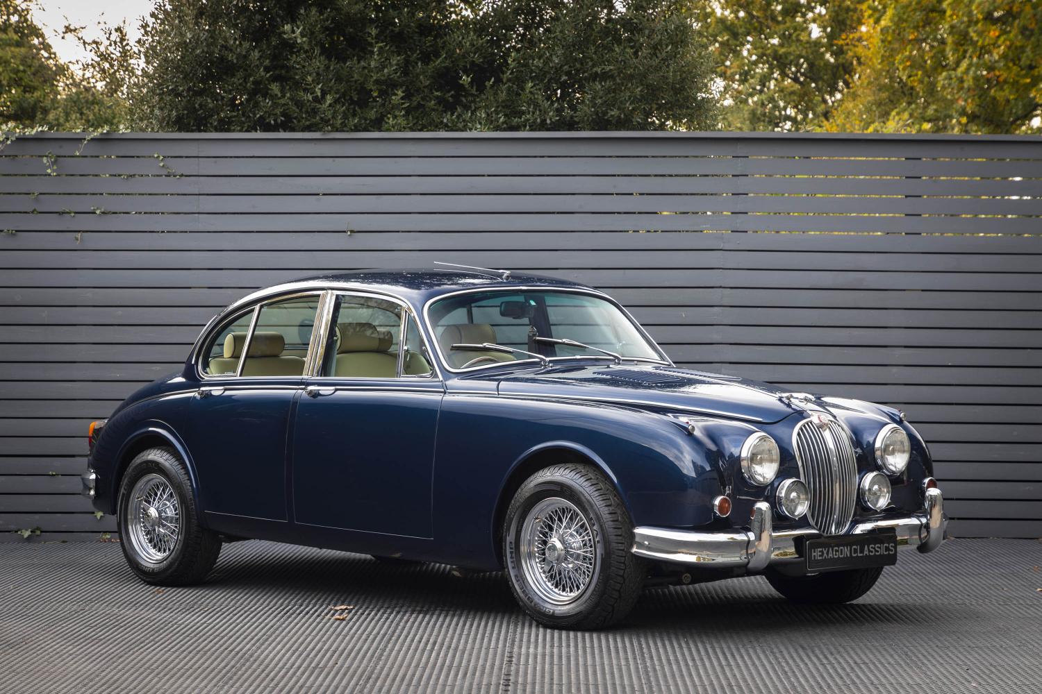 Pictures of your Classic in Action - Page 25 - Classic Cars and Yesterday's Heroes - PistonHeads UK - The image shows a classic blue car parked indoors against a gray background. It appears to be an antique model, possibly a Bentley, as suggested by the distinctive grille and round headlights. The car is in pristine condition, with shiny paint and polished details. The setting seems to be a garage or a similar indoor environment. There are no visible texts or logos on the car that provide additional information about the vehicle or its location.