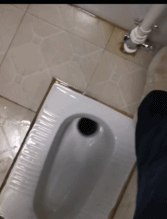 A white toilet sitting in a bathroom next to a sink