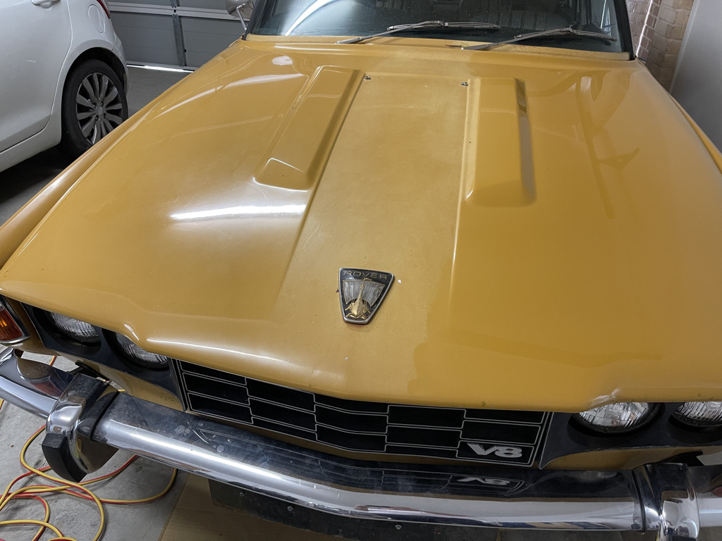 A close up of a red and black motorcycle - Pistonheads - The image shows a vintage car parked inside what appears to be a garage. The vehicle is yellow, featuring a classic design with a prominent front grille and large headlights. It has a black hood and the front end of the car displays a damaged or dented area, possibly indicating that it has been involved in a collision or has experienced other significant wear. The interior of the garage is visible, with tools hanging on the wall and various items scattered around the floor. There are no people present in the image.