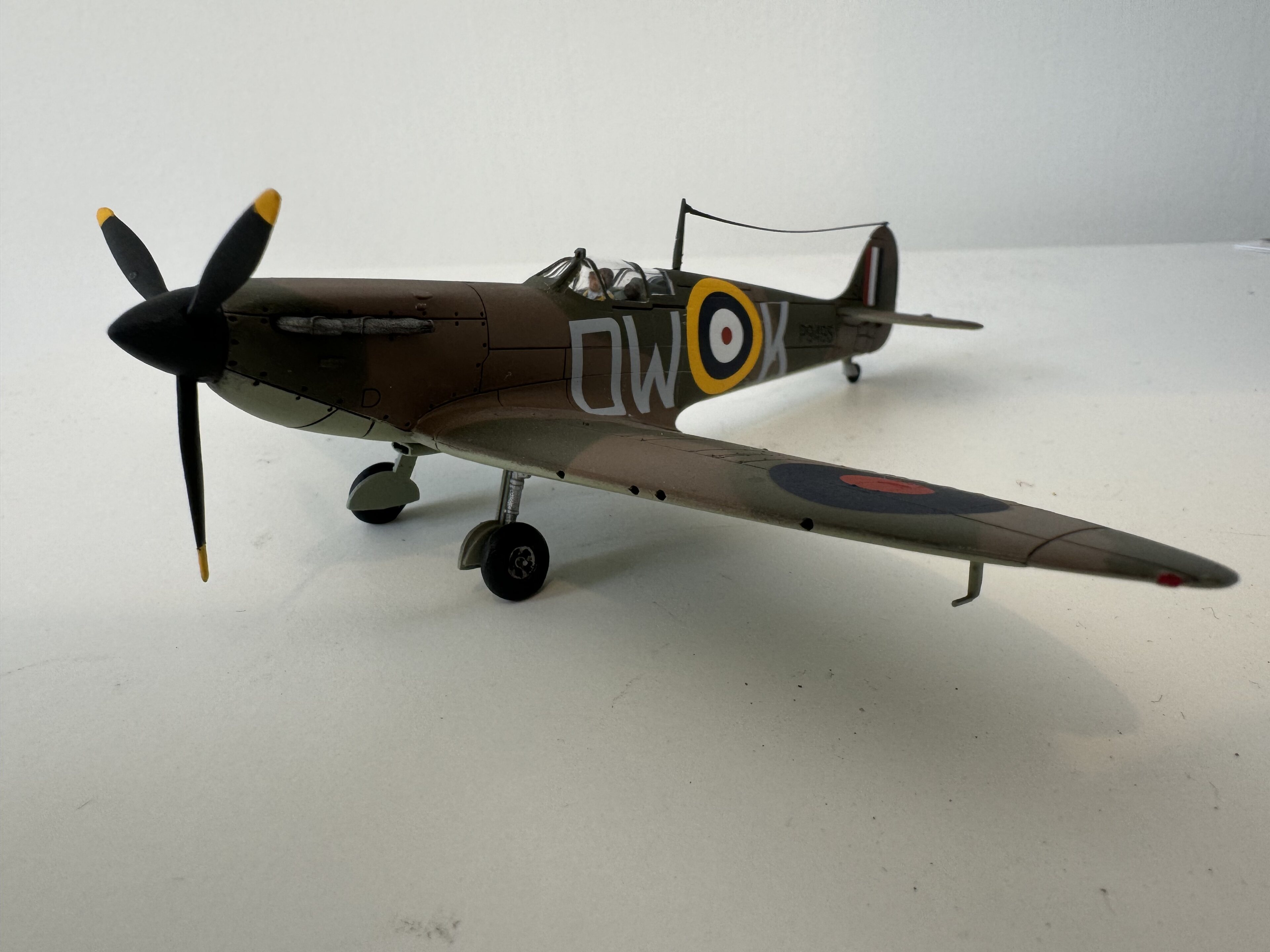 Pistonheads - The image showcases a small-scale model of an airplane, specifically a World War II fighter plane. The airplane is predominantly brown and black in color, with yellow markings on the wings. It's displayed on a tabletop with wheels still attached to the bottom. The background is neutral, providing a clear view of the model aircraft. The model appears to be well-crafted, capturing the details of the historical plane, making it a valuable piece for collectors interested in aviation history.