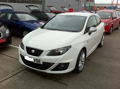 Tdi Pistonheads Seat Ibiza - The image displays a white car with a European-style license plate, indicating it is a vehicle registered in the European Union. The car is parked on an asphalt surface amidst other cars. In the background, there are buildings and roads, suggesting an urban setting. The car appears to be in a showroom or a similar setting for displaying vehicles. The overall tone of the image seems to be a candid photograph capturing the car in its environment.