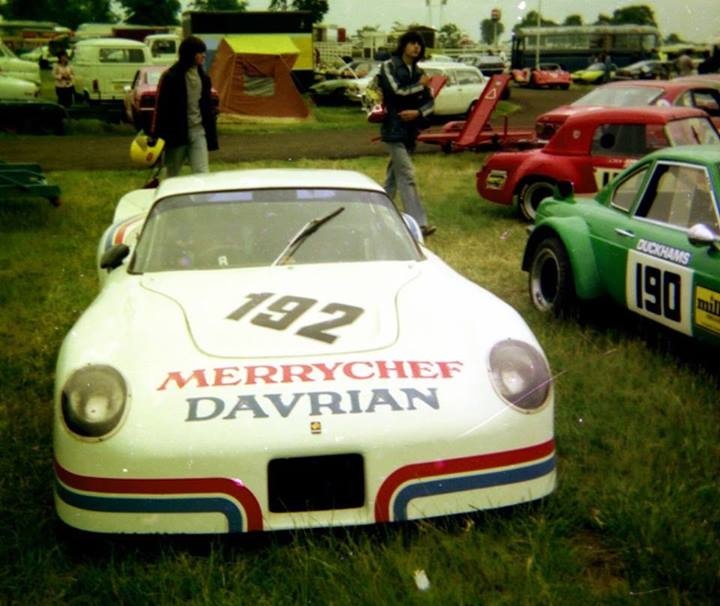 Ginetta G15 identity - Page 1 - Ginetta - PistonHeads - This color photograph captures a vibrant scene set in a grassy, open field. Dominating the foreground is a distinctive white race car, its hood adorned with a Merry Chef Davrian logo and bearing the number 192. This vehicle is parked next to a green race car, which also displays a race number, 190, complementing the distinctive stripe pattern of both cars.

In the background, a variety of other road vehicles can be seen, including cars, trucks, and buses, collectively contributing to a bustling atmosphere. Adding to the scene, there are people scattered throughout the field, some of whom are closer to the camera and others further away. These individuals appear to be enjoying the event, possibly observing or participating in the racing activities.

The openness of the field and the positioning of the cars suggest that this is a raceway or event, where the cars are likely being displayed or prepared for competition. The photo captures a moment of anticipation and excitement, as these powerful machines, beautifully crafted, stand ready for action.