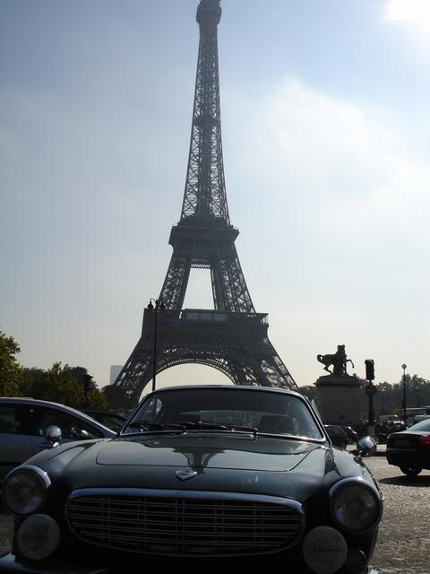 Show us your FRONT END! - Page 123 - Readers' Cars - PistonHeads - The image shows a vintage car parked on the side of a street. In the background, the iconic Eiffel Tower is visible, indicating that the setting is Paris, France. The sky is partly cloudy, suggesting either early morning or late afternoon. There are other cars parked nearby, adding to the urban feel of the scene. The vintage car appears to be in good condition, hinting at its possible maintenance or cherishing by its owner.