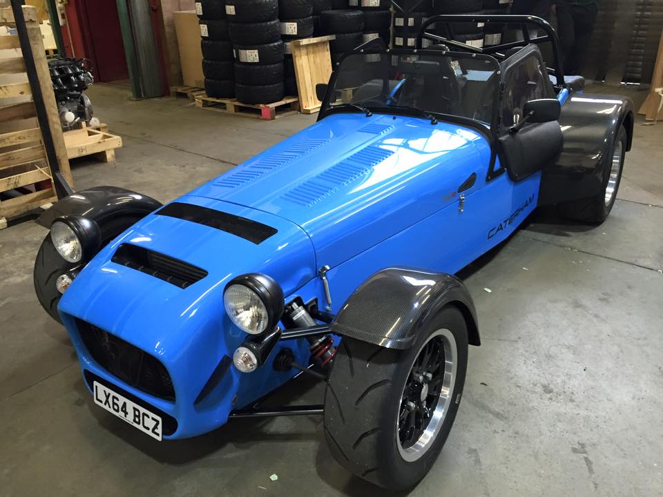 Bullet bitten, GT3 is up for sale, looking at Caterhams... - Page 3 - Caterham - PistonHeads - The image features a striking blue Bugatti-styled kit car parked indoors. The car is sleek in design, with a low body and round, inflated tires. Its front and rear fenders are also blue, matching the body, while its top and side elements are black.