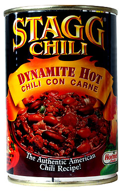 Scrap the Stagg, or give it a new home? - Page 1 - Triumph - PistonHeads - The image is an advertisement for a brand of canned chili. It features the text "HORN - HORN Wing Sliders" prominently displayed at the top, along with the flavor of the product, "Dynamite Hot Chili con Carne." Below the flavor description is a photograph of a bowl of simmering chili, showcasing beans and meat, rendered in a vivid orange and red hue typical of chili. The can's label, with its striking yellow-orange color, graphics, and text, indicates that the brand is "STAGG," and it is a "CHILI." The container is cylindrical, resembling a traditional can design. The can seems to be an opened one, as there is a noticeable view of chili between the layers of the can's ring pull and body. The advertisement emphasizes the chili being authentic American, suggesting that it's a popular choice for taste.