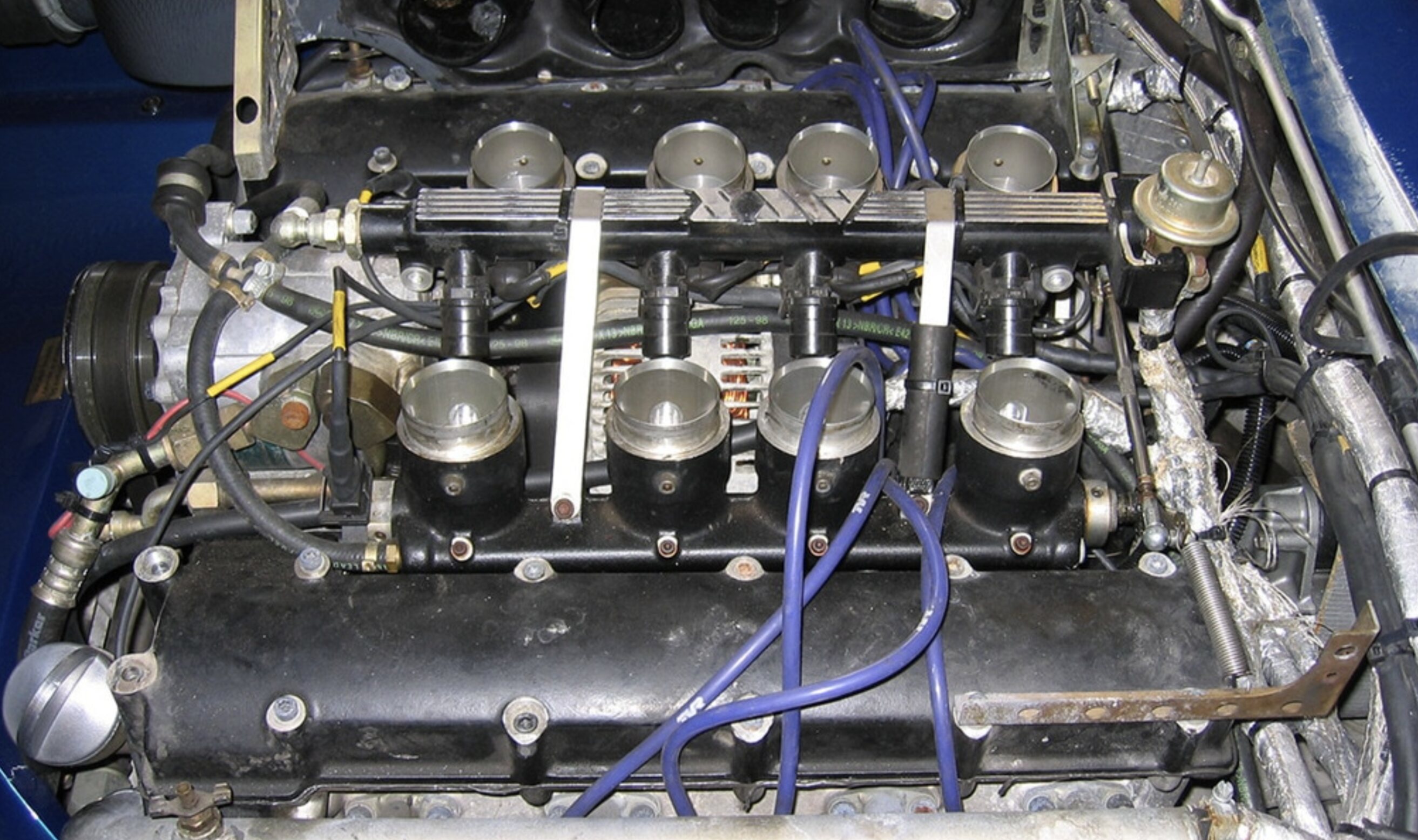 Pistonheads - The image shows an engine inside a vehicle, which appears to be disassembled or in the process of being repaired. There are various components visible, such as gears and metal parts. The engine is set against a darker background, possibly indicating that the photo was taken during maintenance or inspection. This kind of work could involve cleaning, repairing, or replacing parts within the engine.