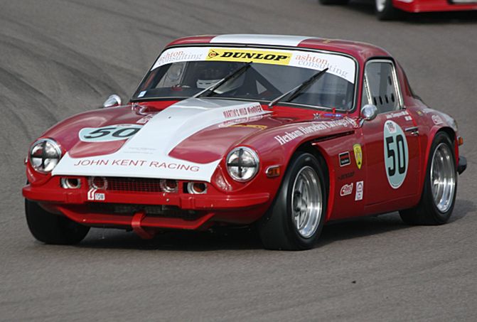 Pictures of your racecar thread - Page 1 - UK Club Motorsport - PistonHeads - The image shows a vintage racing car, possibly a Dunlop, on a track. The car is a vibrant red with white and yellow detailing and has the number "50" prominently displayed on its hood. It's mid-motion with its front wheel slightly raised, suggesting speed or acceleration. The background indicates that it is on a race track.