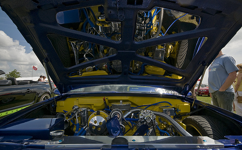 Pistonheads Truck Chevy - The image captures a vibrant blue and yellow classic car open for an engine wax off event at a car show. The hood of the car is propped up, revealing the intricate details of the engine. One can see various car parts like strings and belts, suggesting a rigorous tune-up or polish. A black duffel bag rests nearby, possibly containing tools or cleaning supplies for the event. In the background, people mill about, likely attendees of the car show appreciating the display or milling about in general.