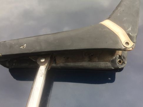 A close up of a train on a track - Pistonheads - The image displays a close-up view of the underside of a left motorcycle handlebar. Visible is the distinct three-sided cap, colored in black with a white grip tape, and a metallic lever underneath, which is part of the brake mechanism. Additionally, a specialized adapter is visible, designed to secure the handlebar to the motorcycle frame, ensuring a proper and safe connection for the rider. The handlebar itself appears to be in good condition, with no visible damage, indicating it is a spare or being prepared for a rider.