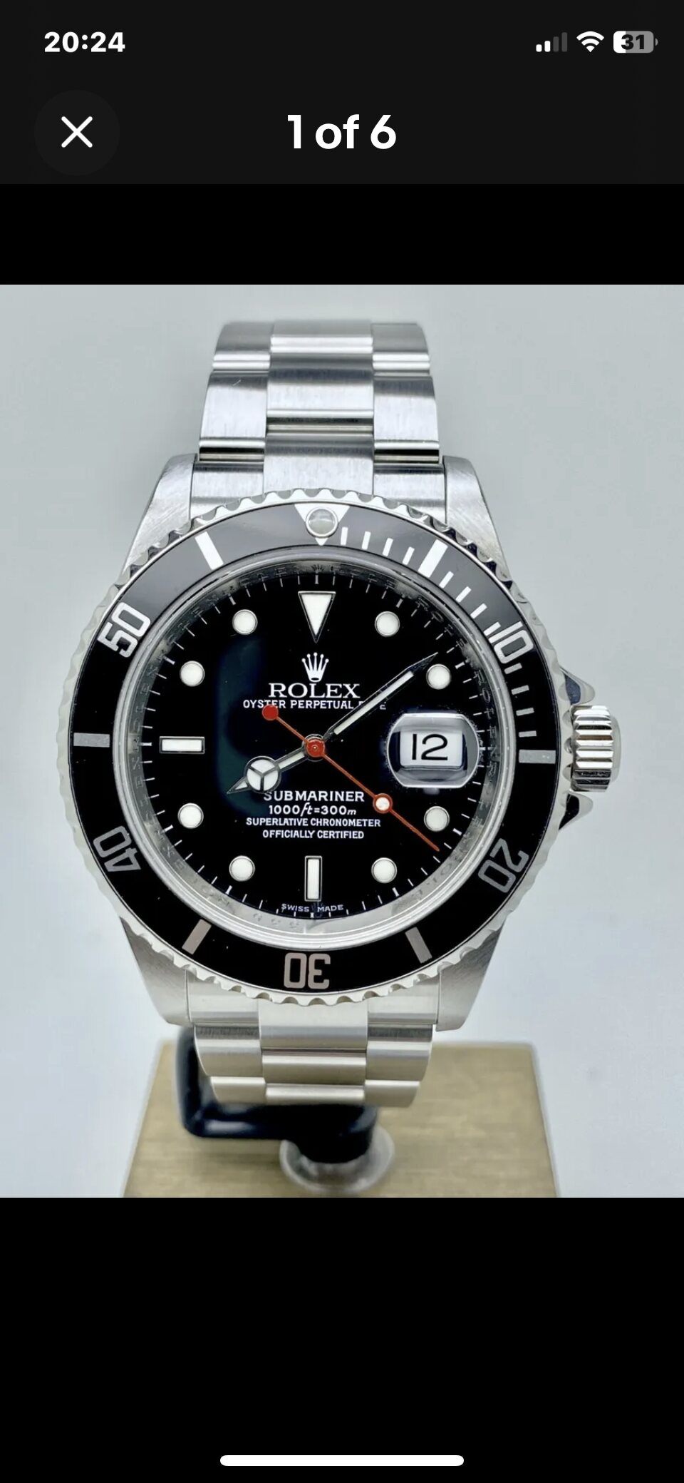 Pistonheads - The image showcases a close-up view of a Rolex watch. The watch features a silver band and is adorned with the iconic Rolex logo on the face, along with other distinguishing elements typical of Rolex watches. The screen displays a picture of the watch, while the phone's camera is pointing directly at it, capturing its intricate details.