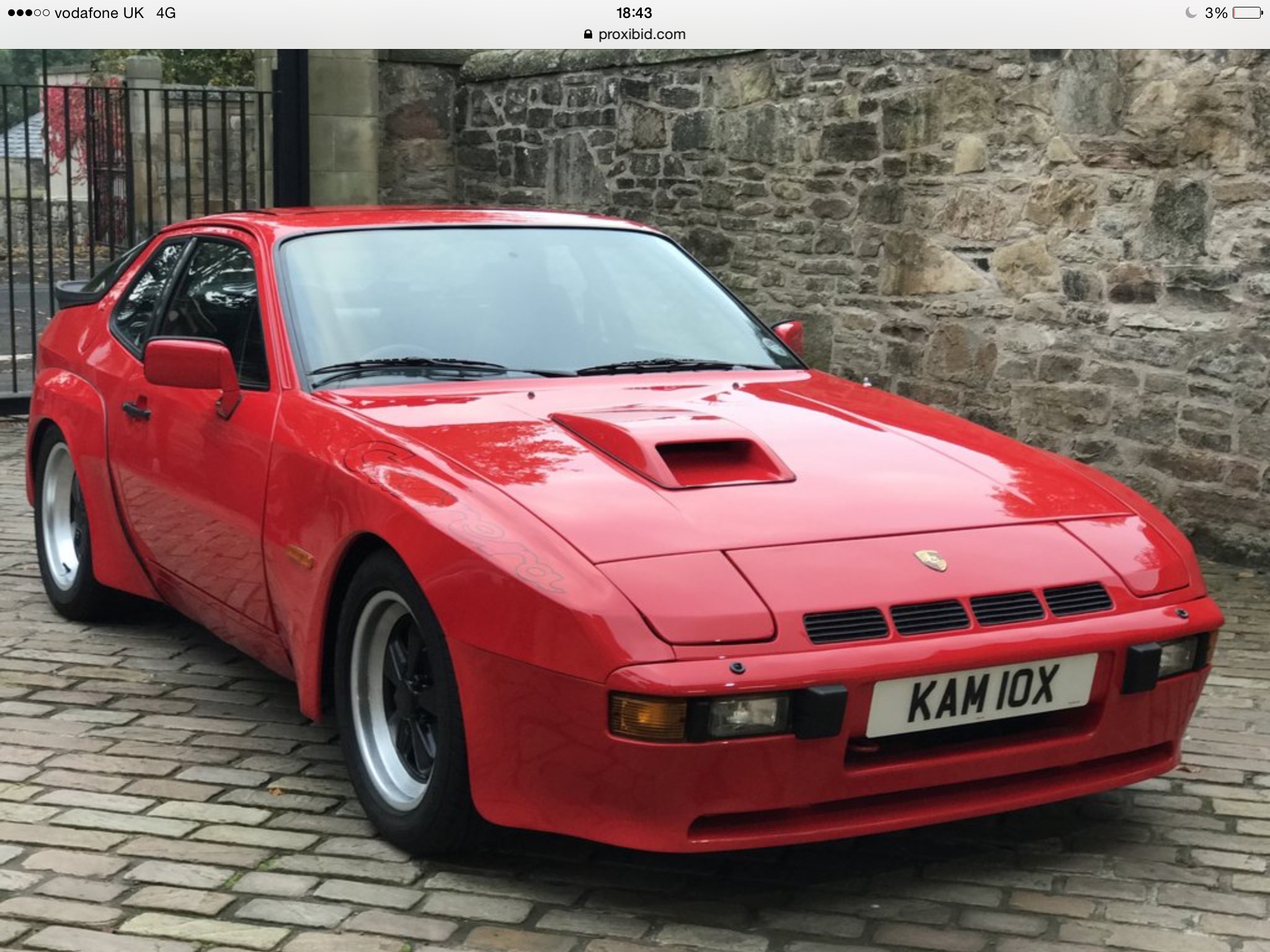 924 Carrera GT - Page 4 - Front Engined Porsches - PistonHeads - The image features a striking red Porsche 911 with a slightly raised bonnet. The car is positioned on a brick pavement, contrasting with the urban environment it sits within. The vehicle's license plate is clearly visible, potentially revealing its registration details. The overall composition of the image suggests a well-maintained vintage sports car on display, likely parked outdoors.