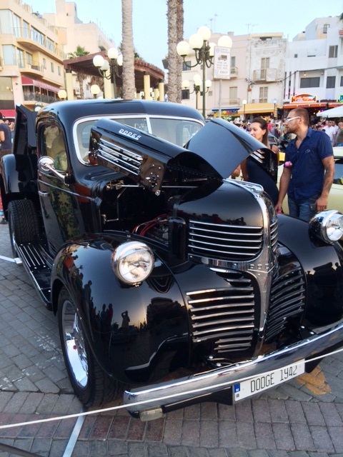 In Malta last week - Page 1 - Yank Motors - PistonHeads - This image features a classic black automobile parked on a brick roadway. The car's vintage design suggests it may be an antique or collectible model. In the background, the street is lined with white buildings, which add to the old-fashioned aesthetic of the scene. There are a few people on the sidewalk, casually dressed and going about their day. The overall atmosphere of the image seems to be calm and serene, evoking a sense of nostalgia from a bygone era.