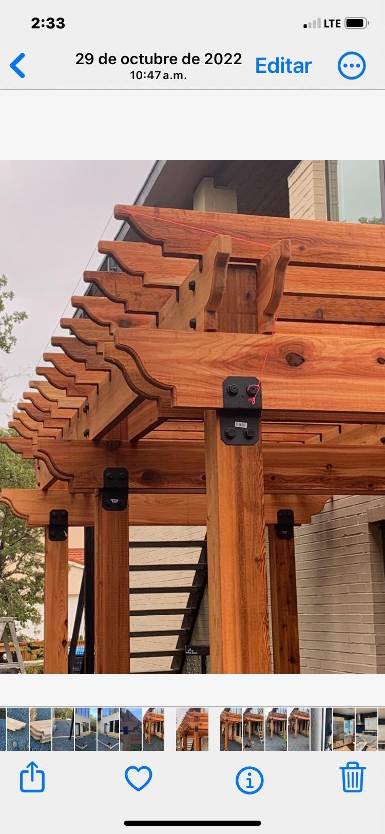 Hand-built custom cedar pergola with carved rafter tails