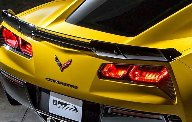 C7 Z06  - Page 1 - Corvettes - PistonHeads - The image captures a close-up view of the tail end of an illuminated Chevrolet Corvette ZR1, showcasing its rear brake lights and black and silver logo of the Corvette emblem, set against a dark backdrop. The design of the brake lights is sleek and modern, adding to the sporty aesthetic of the car. The logo is prominently displayed, indicating the make and model of the vehicle. The overall impression is of a powerful and premium sports car.