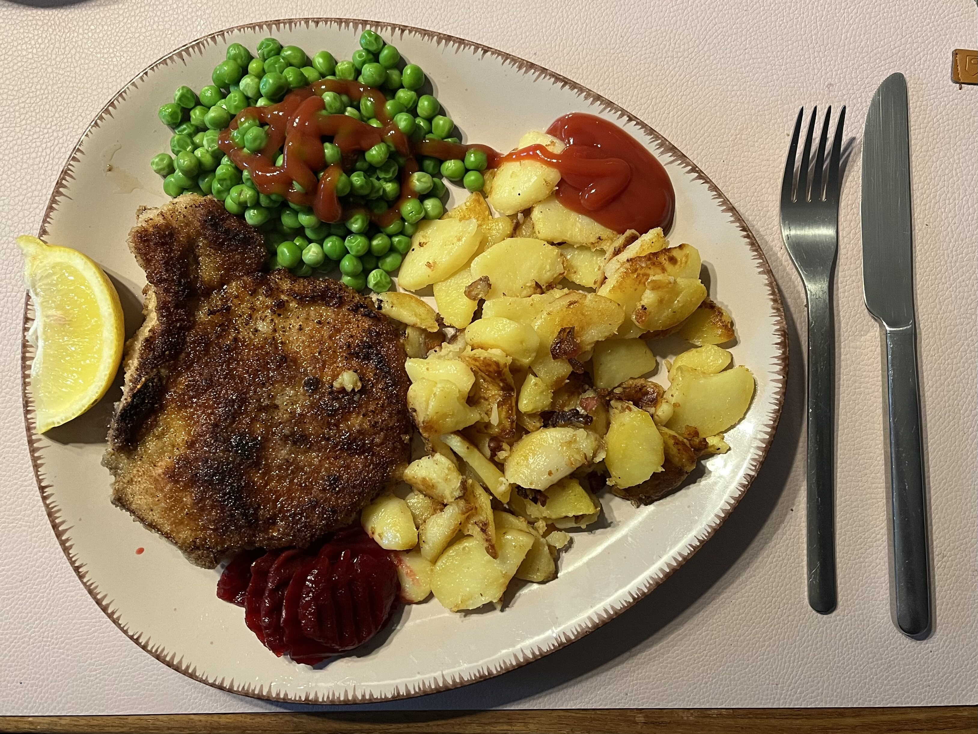 Photo of your dinner (Vol 3) - Page 654 - Food, Drink & Restaurants - PistonHeads UK - The image shows a dinner plate filled with various food items. On the left side of the plate, there's a serving of what appears to be peas or green beans. The main protein on the plate is fish fillets, which have a golden-brown crust and are likely breaded. To the right, there is a generous portion of golden french fries. Accompanying these main items, there are dollops of sauce, possibly ketchup or another type of red condiment, and sour cream, served as a side dish. The plate is presented on a dining table, and a fork and knife rest beside the plate, ready for use. There's no visible text in the image.