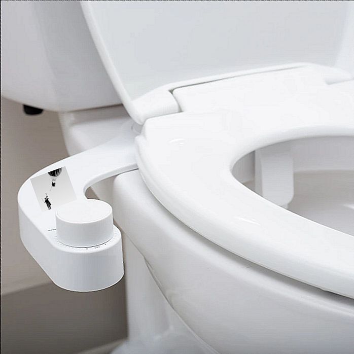 A white toilet sitting in a bathroom next to a sink