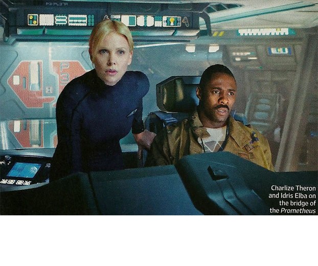 Prometheus - Ridley Scott's 'Alien Prequel' (or not)... - Page 5 - TV, Film & Radio - PistonHeads - The image is a photograph featuring two individuals, a woman and a man, in what appears to be a futuristic flying spacecraft. The woman, on the left, looks concerned or tense, with her gaze directed at the camera, mouth partially open as if she's in the middle of speaking. The man, seated next to her, has a slight frown and his eyes are focused to his right, not making direct eye contact with the viewer. They are both dressed in uniform in shades of blue and darker blue-green, which matches the interior environment of sleek and angular console panels and panels of buttons and screens around them.

In the bottom right corner of the image, against a thin white line, there's text that reads "Charlize Theron and Idris Elba on the bridge of the Prometheus," which identifies the actors in the image and explains their setting. The setting suggests a narrative context, possibly related to a science fiction or space exploration theme. The photograph captures a moment that seems to convey tension or anticipation, fitting the theme for such a setting.