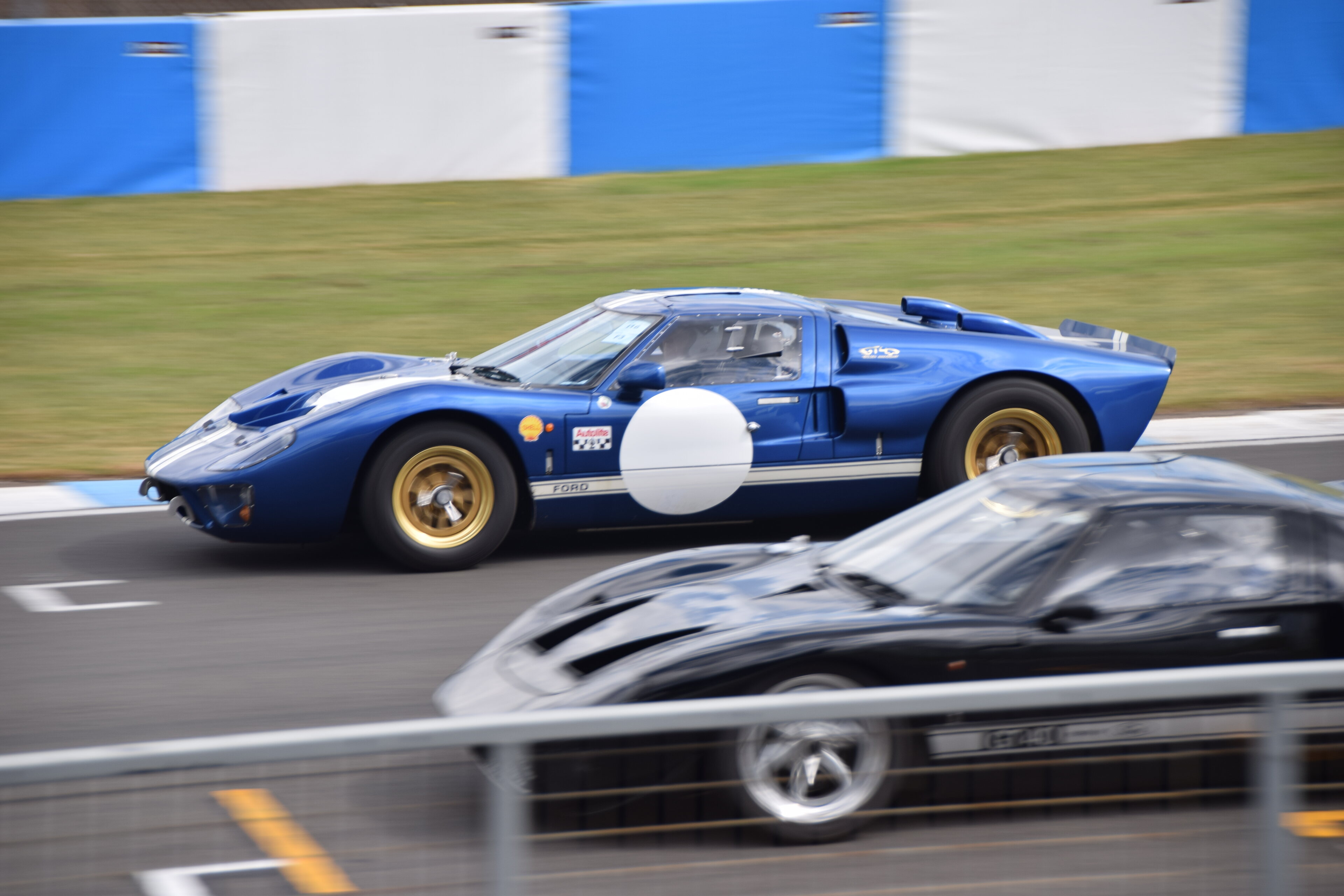 A car that is sitting in the street - Pistonheads - The image captures a thrilling moment at a car racing event. Two race cars, one blue and the other black, are in close proximity on a track, possibly indicating an overtake maneuver. The background reveals a blue fence typical of racetracks, suggesting that the photo was taken during a professional motorsport competition.