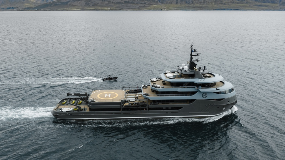 Post Amazingly Cool Pictures Of Ships or Boats! - Page 71 - Boats, Planes & Trains - PistonHeads UK - The image showcases a luxury yacht, large in size and prominent in the frame. It's equipped with a helicopter pad on top, suggesting it's designed for extensive travel capabilities. The vessel is seen sailing on open water, indicating motion and activity. In the background, there's a glimpse of a landmass or coastline under a clear sky. The yacht's sleek design and modern amenities are evident, reflecting the high-end nature of such vessels.