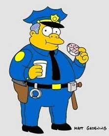 Pistonheads - The image features an animated police officer standing against a plain background. The officer, who is the central figure, is dressed in standard police uniform, complete with badge, cap, coat, and tie. He holds a tall coffee cup in his left hand. In his right hand, he holds a doughnut decorated with sprinkles. The image has a cartoonish style, suggesting it is aimed at a general audience and possibly intended for a young demographic.